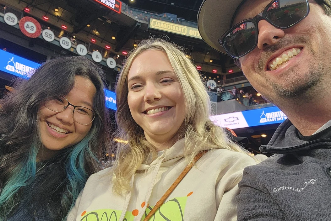 Three of the team at a ball game